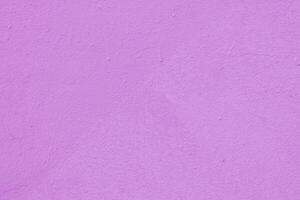 Pink wall of the building. Rough plaster surface. Abstract background. photo