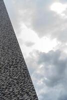Corner of a modern brick building against the sky. Diagonal at an angle. photo