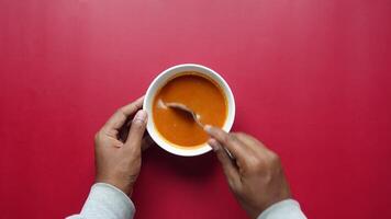 top view of fresh tomato soup in a bowl video