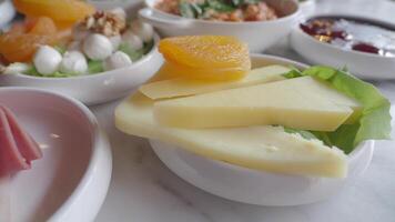 A Delicious and Appealing Assortment of Cheese and Pickles Displayed on a White Plate video