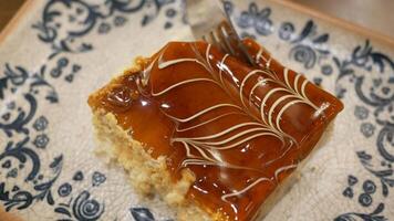 Caramel custard pudding on a plate on table video