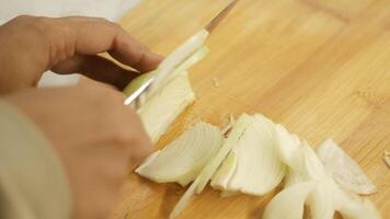 Carefully Chopping Onion with a Sharp Knife on a Sturdy Wooden Cutting Board Surface video