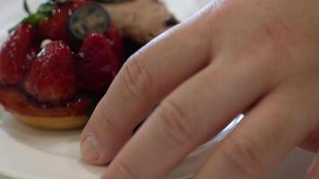 close up to set of sweet dessert cake and macaroon while using hand to grab macaroon to eat in afternoon tea time video
