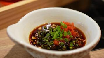 Sliced Scallions and Minced Carrot were Mixed into Ponzu Sauce at Sukiyaki Restaurant video