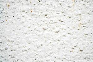 White texture of uneven plaster covering the wall. Building background. photo