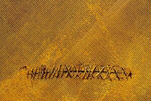 Yellow net. Wired hole. Texture of yellow surface. photo