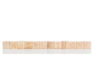 Wooden cubes with letters instructions on a white background photo