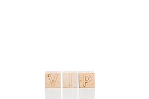 Wooden cubes with letters vip on a white background photo
