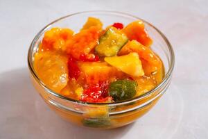 Rujak aceh or Rojak is dish from Java. Rujak consists of a mixture of sliced fruit and vegetables served with spicy palm sugar sauce. photo