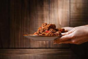 Rendang Pork. Rendang is an Indonesian West Sumatra Minangkabau spicy meat. that slow cooked in coconut milk and mixed spices. photo