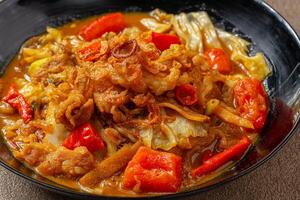 Tongseng is beef stew dish in curry-like soup, with vegetables and sweet soy sauce photo