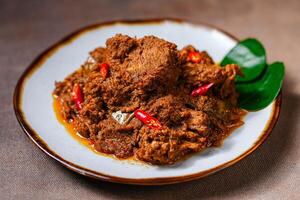 Rendang Pork. Rendang is an Indonesian West Sumatra Minangkabau spicy meat. that slow cooked in coconut milk and mixed spices. photo