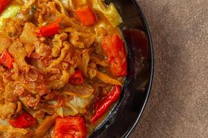 Tongseng is beef stew dish in curry-like soup, with vegetables and sweet soy sauce photo