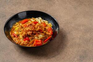 Tongseng is beef stew dish in curry-like soup, with vegetables and sweet soy sauce photo