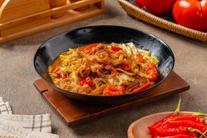 Tongseng is beef stew dish in curry-like soup, with vegetables and sweet soy sauce photo