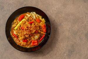 Tongseng is beef stew dish in curry-like soup, with vegetables and sweet soy sauce photo