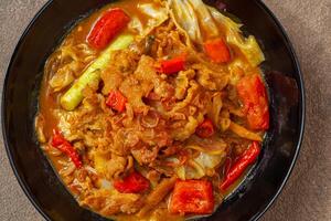 Tongseng is beef stew dish in curry-like soup, with vegetables and sweet soy sauce photo
