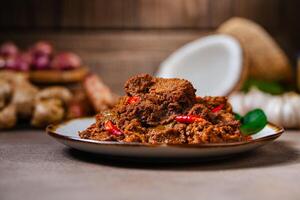 Rendang Pork. Rendang is an Indonesian West Sumatra Minangkabau spicy meat. that slow cooked in coconut milk and mixed spices. photo