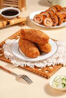 Pempek is a savoury Indonesian fishcake delicacy, made of fish and tapioca from Palembang. Pempek is served with sweet and sour sauce. photo