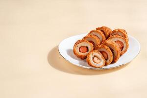 Pempek is a savoury Indonesian fishcake delicacy, made of fish and tapioca from Palembang. Pempek is served with sweet and sour sauce. photo