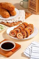 Pempek is a savoury Indonesian fishcake delicacy, made of fish and tapioca from Palembang. Pempek is served with sweet and sour sauce. photo