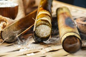 Lemang. Glutinous rice is wrapped with lerek or banana leaf encased in bamboo culm and cooked in open fire. photo