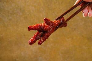 Spicy chicken feet or ceker ayam pedas with chili photo