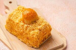 Nastar Cake is vanilla sponge based with crumbs, layered by pineapple jam and cheese cream. Topping with nastar cookies crumbs photo