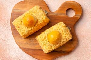 Nastar Cake is vanilla sponge based with crumbs, layered by pineapple jam and cheese cream. Topping with nastar cookies crumbs photo