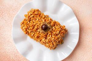 Mocha nougat caramel cake with chocolate chip on top photo