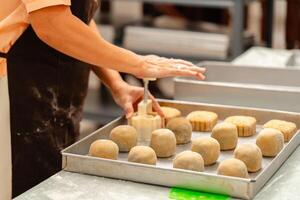 Mooncake making process. A mooncake is a Chinese bakery product traditionally eaten during the Mid Autumn Festival. photo