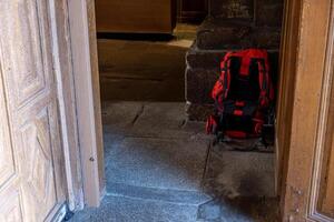 backpack of a pilgrim in a church on the Way of St. James, peregrination concept photo