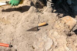 trowel on the ground in an archaeological dig, archeology concept photo