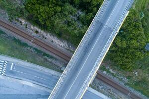 overhead aerial view of a highway and railway overpass photo