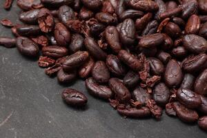 Cocoa beans on black table background photo
