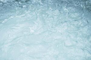 Turbulent water surface with visible foam and ripples. photo