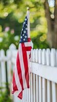American Flag Draped Over Fence photo