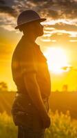 Silhouette of Worker at Sunset with American Flag photo