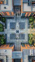 Aerial view of a modern urban courtyard with symmetrical architecture, rooftop gardens, and pathways between buildings in a vibrant city environment photo