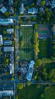 Aerial view of a sports complex with surrounding buildings and green spaces photo