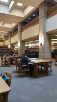 Students Studying in a Modern University Library with Natural Light photo