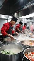 Professional chefs cooking in a busy commercial kitchen with steam photo