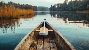 Serene Canoe Ride on a Calm Lake with Autumn Foliage in the Background photo