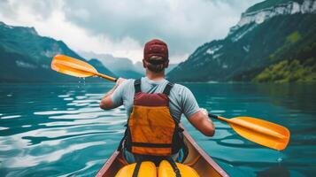 Canoeist Paddling in Scenic Lake photo