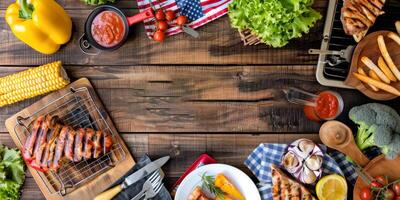 Barbecue spread with various grilled meats and vegetables on wood table photo