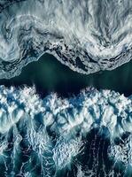 Dramatic aerial view of powerful ocean waves with foam patterns photo