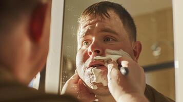 Young man with Down syndrome learning how to shave with foam on his face photo