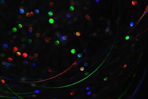 Abstract black background with bokeh of different colors. photo