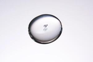 A smear of cosmetic gel close-up on a gray background. Appetizing texture with bubbles. photo