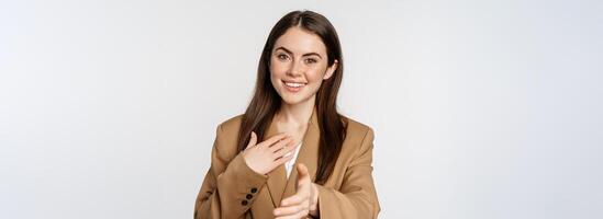 Portrait of smiling businesswoman extend hand for handshake, greeting business partner, saleswoman welcome client, white background photo